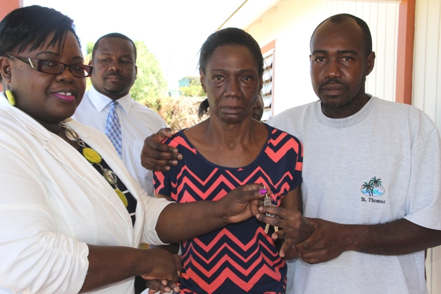 Junior Minister in the Ministry of Social development Hazel-Brandy Williams hands keys to a new home to Ms. Lynette Koram at Jessups Village on March 10, 2017, flanked by her son care taker Lesroy Koram. Looking on is Permanent Secretary in the Ministry of Social Development Keith Glasgow